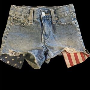 Denim Girls Shorts with American Flag pockets hanging below the shorts. Cute!